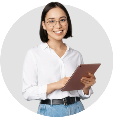 A lady wearing glasses smiles while holding a tablet computer.