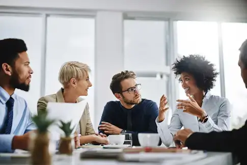 A teams works together around a table.